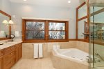 Primary bathroom offers jetted tub and steam shower 
